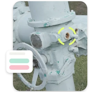 Inspector review of highlighted corrosion on industrial valve with visual status indicators